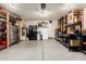 Two car garage with a utility door, freezer, water heater and a work bench area at 13359 W Post Dr, Surprise, AZ 85374
