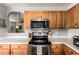 Close-up view of a clean kitchen showcasing modern oven with stainless steel, countertops, and cabinets at 13359 W Post Dr, Surprise, AZ 85374