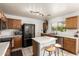 Efficient kitchen with ample counter space, black appliances, and natural-toned cabinets at 13359 W Post Dr, Surprise, AZ 85374
