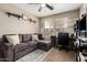 The living room features a sectional sofa, a ceiling fan, and decor for a relaxing atmosphere at 13359 W Post Dr, Surprise, AZ 85374