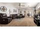 Spacious living room featuring comfortable seating, an open layout, and seamless flow to dining area at 13359 W Post Dr, Surprise, AZ 85374
