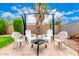 Beautiful outdoor patio with a gazebo, paved stone and lush landscaping. Firepit is ready to enjoy at 13359 W Post Dr, Surprise, AZ 85374