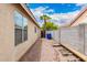 Gravel side yard with access gate to the backyard, utility access and block wall fencing at 13359 W Post Dr, Surprise, AZ 85374