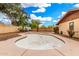 Empty pool in backyard with rock landscaping, surrounded by privacy fence at 134 E Le Marche Ave, Phoenix, AZ 85022