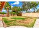 Spacious backyard featuring a brick fence, palm trees, and lush greenery at 134 E Le Marche Ave, Phoenix, AZ 85022