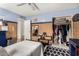 Bedroom featuring blue walls, bamboo accents, closet, and a stylish geometric rug at 134 E Le Marche Ave, Phoenix, AZ 85022