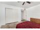 A bedroom featuring a large closet and ceiling fan with potential for renovation at 134 E Le Marche Ave, Phoenix, AZ 85022