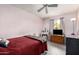 Comfortable bedroom with a full-size bed, wooden dresser, and ample natural light from the window at 134 E Le Marche Ave, Phoenix, AZ 85022