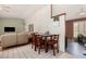 Cozy dining area with a wood table and four chairs, adjacent to the living room at 134 E Le Marche Ave, Phoenix, AZ 85022