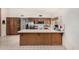 Spacious kitchen featuring a breakfast bar, tile floors, and stainless steel appliances at 134 E Le Marche Ave, Phoenix, AZ 85022