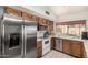 Well-lit kitchen with a stainless steel refrigerator, white appliances and tiled countertops at 134 E Le Marche Ave, Phoenix, AZ 85022