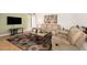 Bright living room with a plush sofa, a large rug, and a view to the dining area at 134 E Le Marche Ave, Phoenix, AZ 85022