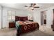 Bright main bedroom with a decorative bedspread, white walls, and shuttered windows at 134 E Le Marche Ave, Phoenix, AZ 85022