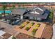 An aerial view shows the clubhouse, pool, shaded lounge area and garden plots at 14549 W Corrine Dr, Surprise, AZ 85379