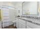 Bathroom with a granite counter, window, and shower with curtain at 14549 W Corrine Dr, Surprise, AZ 85379
