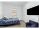 Comfortable bedroom features a TV, chair, and neutral decor at 14549 W Corrine Dr, Surprise, AZ 85379