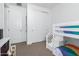 Bright bedroom features a white bunk bed, closet and white doors at 14549 W Corrine Dr, Surprise, AZ 85379