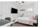 Well-lit bedroom with a large bed, a desk, and modern decor at 14549 W Corrine Dr, Surprise, AZ 85379