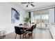 Modern dining room with a wooden table, black chairs, and sliding glass doors to the backyard at 14549 W Corrine Dr, Surprise, AZ 85379