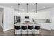 Stylish kitchen featuring a large island with seating, white cabinets, and stainless steel appliances at 14549 W Corrine Dr, Surprise, AZ 85379