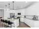 Bright kitchen with white cabinets, granite countertops, and a stainless steel refrigerator and microwave at 14549 W Corrine Dr, Surprise, AZ 85379