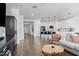 Open-concept living space showcasing hardwood floors, a kitchen with bar seating, and stylish furnishings at 14549 W Corrine Dr, Surprise, AZ 85379