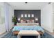 Cozy main bedroom with a king-sized bed and a dark accent wall at 14549 W Corrine Dr, Surprise, AZ 85379