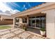 Covered patio featuring seating, outdoor access, and lush landscaping at 14549 W Corrine Dr, Surprise, AZ 85379