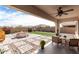 Covered patio featuring ample seating, dining area, and manicured landscaping at 14549 W Corrine Dr, Surprise, AZ 85379