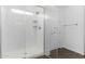 Tiled shower with a built-in seat and a glass door at 14549 W Corrine Dr, Surprise, AZ 85379