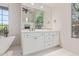 Bright bathroom with a soaking tub, bright natural light and vanity at 14619 E Desert Vista Trl, Scottsdale, AZ 85262
