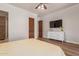 Bedroom featuring wood floors, a ceiling fan, and closet access to a bathroom at 14619 E Desert Vista Trl, Scottsdale, AZ 85262
