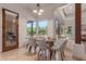 Dining room with a glass table, view to the backyard, and white walls at 14619 E Desert Vista Trl, Scottsdale, AZ 85262