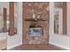 Close up shot of the stone fireplace with a wood mantel and a glass enclosure at 14619 E Desert Vista Trl, Scottsdale, AZ 85262