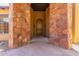 Grand entryway with stone archway and wooden door at 14619 E Desert Vista Trl, Scottsdale, AZ 85262