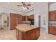 Spacious kitchen featuring custom wood cabinets, large center island with granite countertop, and tile flooring at 14619 E Desert Vista Trl, Scottsdale, AZ 85262