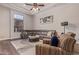 Cozy living room with a large sectional sofa, tray ceiling, and natural lighting at 14619 E Desert Vista Trl, Scottsdale, AZ 85262