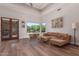 Spacious living room with hardwood floors, large window, and leather sofa at 14619 E Desert Vista Trl, Scottsdale, AZ 85262