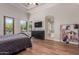 Cozy primary bedroom suite with wood floors, natural light, and ensuite bath entrance at 14619 E Desert Vista Trl, Scottsdale, AZ 85262