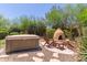 Backyard with spa and outdoor pizza oven surrounded by desert landscaping at 14619 E Desert Vista Trl, Scottsdale, AZ 85262