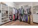 Walk-in closet boasts custom shelving and rods to maximize storage space, complete with wood flooring at 14619 E Desert Vista Trl, Scottsdale, AZ 85262