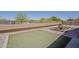 Desert landscaping with artificial turf framed by paver stones and a concrete block wall at 1726 E Primera Dr, Casa Grande, AZ 85122