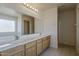 Bright bathroom featuring a double vanity with a large mirror and tile flooring at 1726 E Primera Dr, Casa Grande, AZ 85122