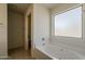 Clean bathroom featuring a soaking tub with tiled floor and frosted window at 1726 E Primera Dr, Casa Grande, AZ 85122