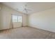 Bright bedroom featuring neutral carpet, a ceiling fan, and a window with blinds at 1726 E Primera Dr, Casa Grande, AZ 85122