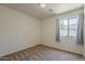 Bedroom with neutral carpet, a ceiling light and a window providing outside view at 1726 E Primera Dr, Casa Grande, AZ 85122