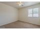 Cozy bedroom with neutral carpet, ceiling fan and a window for natural light at 1726 E Primera Dr, Casa Grande, AZ 85122