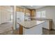 Well-lit kitchen featuring tile floors, center island, white appliances, and wood cabinets at 1726 E Primera Dr, Casa Grande, AZ 85122