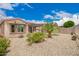 A well landscaped backyard with a grill, lush vegetation and gravel covering the ground at 17907 W Cedarwood Ln, Goodyear, AZ 85338