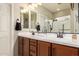 This bathroom features a double sink vanity, updated fixtures, and a glass enclosed shower at 17907 W Cedarwood Ln, Goodyear, AZ 85338